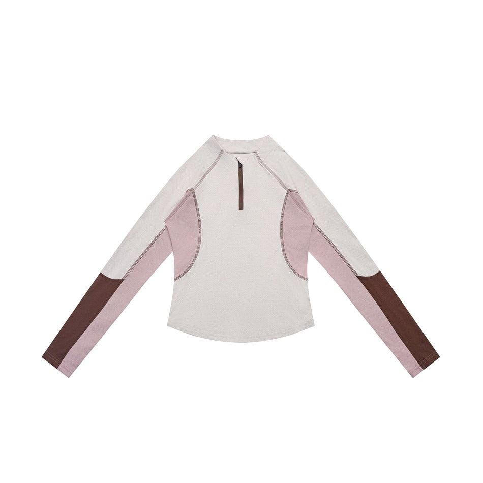 Beige half-zip long-sleeve top with dusty pink side panels and brown sleeve ends, flat lay on white