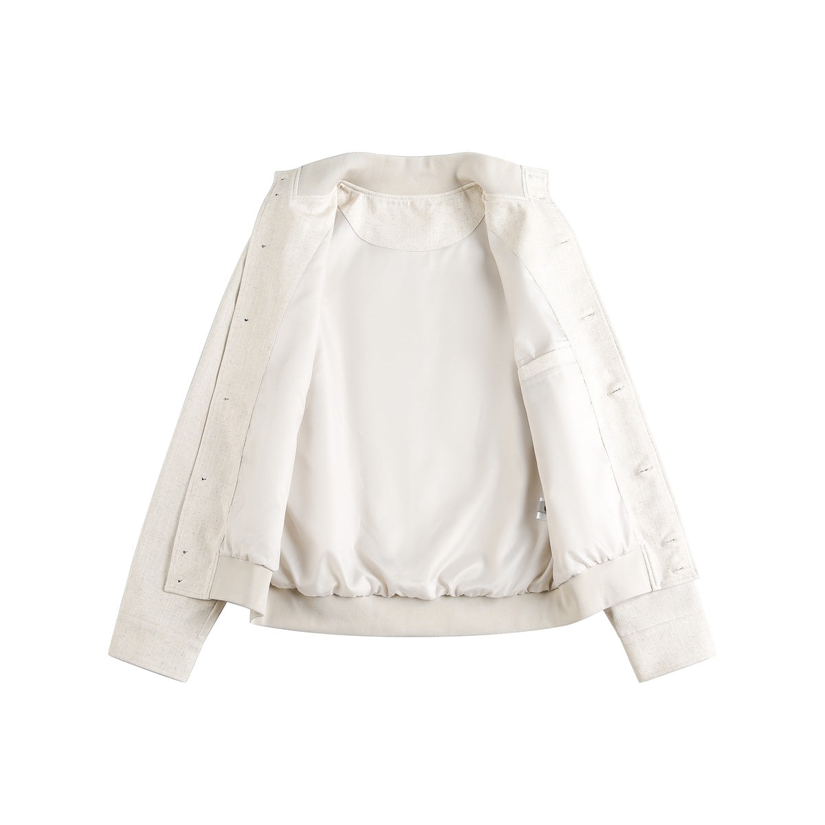 Open ivory jacket laid flat, showing its smooth light lining, inner pocket, cuffs, and front fastening edge.