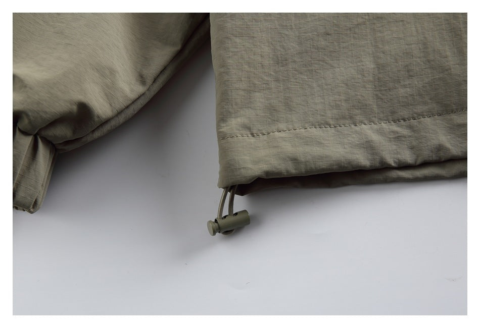 Close-up of the jacket hem showing a drawcord and adjustment toggle.