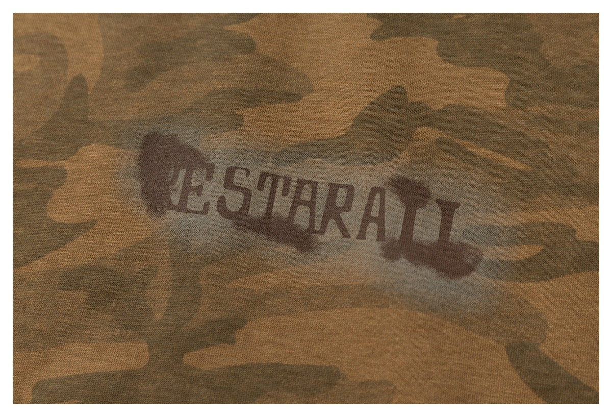 Close-up of a dark English wordmark printed on brown camouflage fabric.