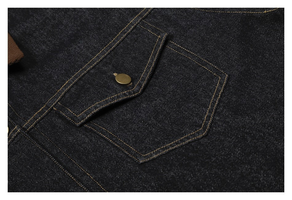 Close-up of a buttoned chest pocket on dark denim, with contrast stitching and a brass-tone button.