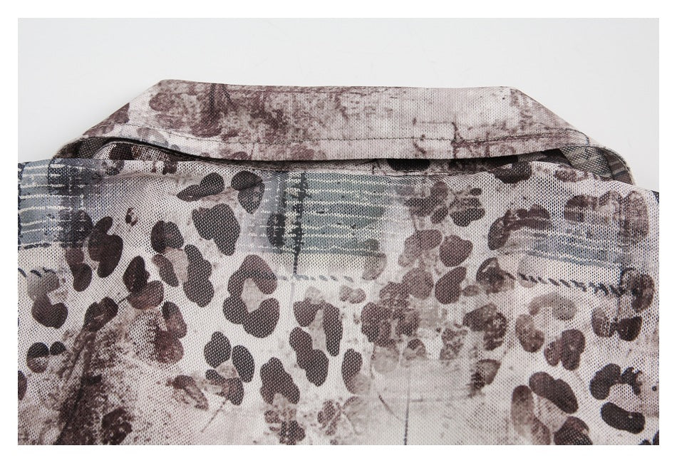 Close-up of the garment's back collar and abstract brown, cream, and blue-gray print.