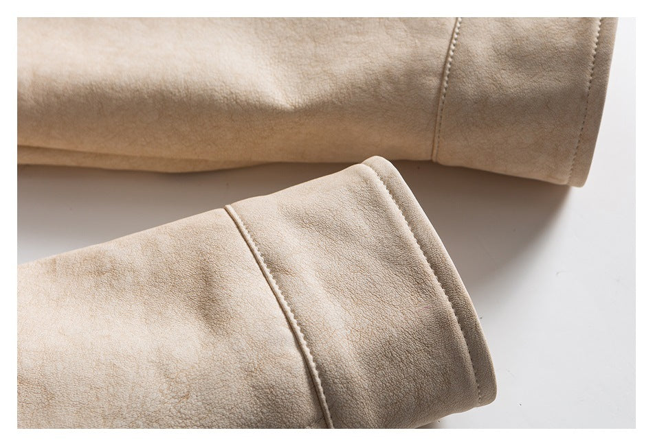 Close-up of the cream jacket's sleeve cuffs and stitched seam details.