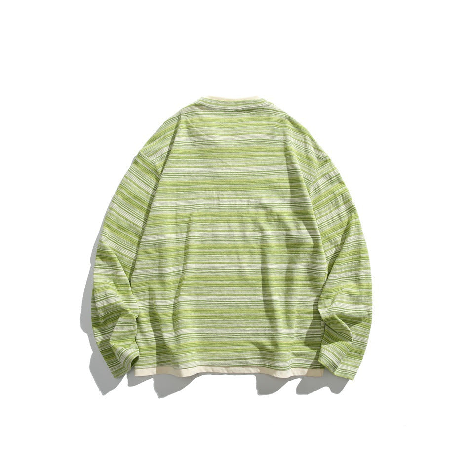 Back view of a green-and-white striped long-sleeve shirt laid flat.