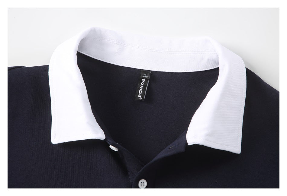Close-up of a navy polo shirt with a white collar, button placket, and visible neck label.