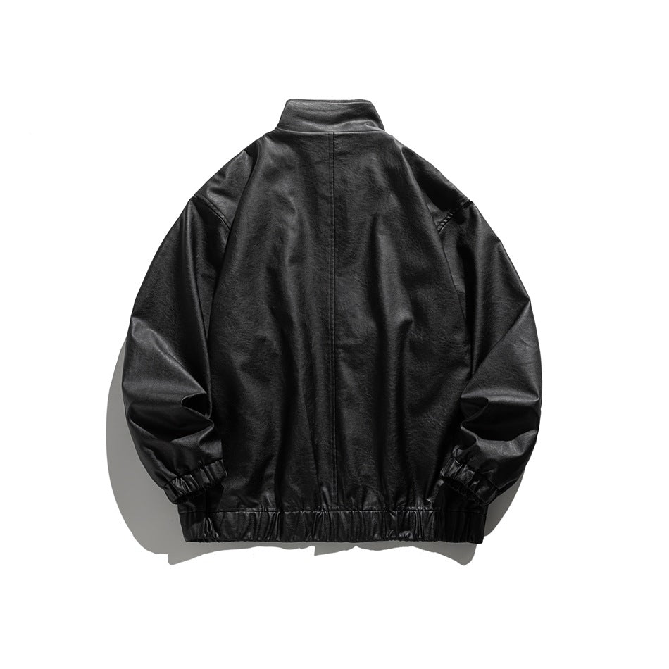 Back view of a black jacket laid flat, with a stand collar, long sleeves, and gathered cuffs and hem.