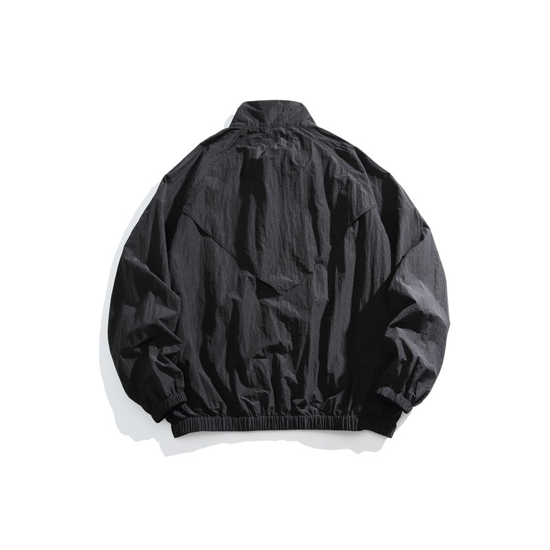 Black jacket shown from the back, with a layered flap, high collar, elastic cuffs and hem.