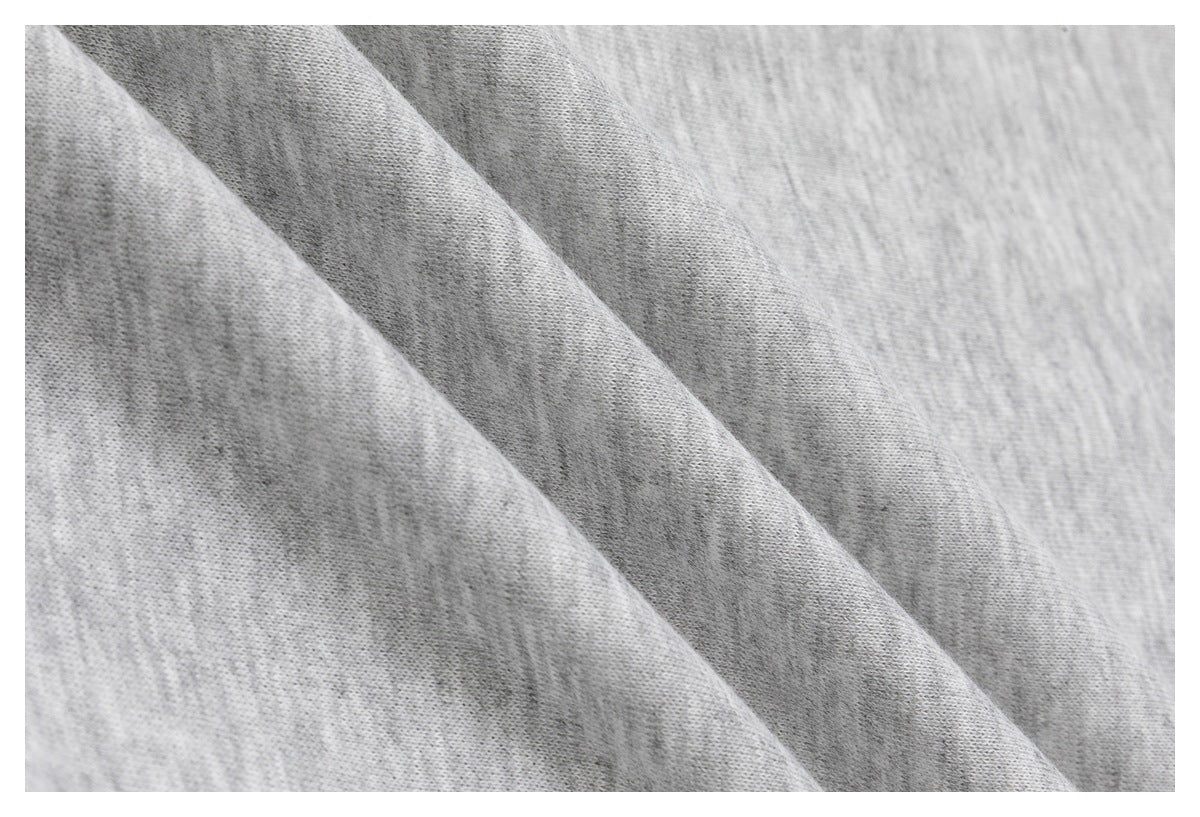 Extreme close-up of the light gray garment fabric, showing its surface and folds.
