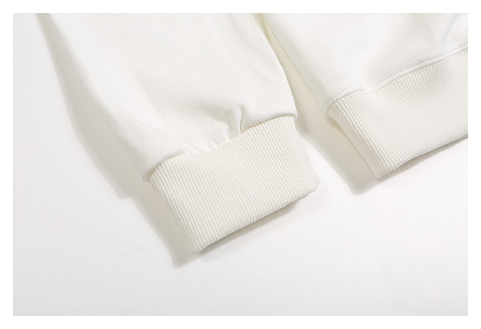 Close-up of off-white sweatshirt sleeve cuffs and ribbed hem bands.