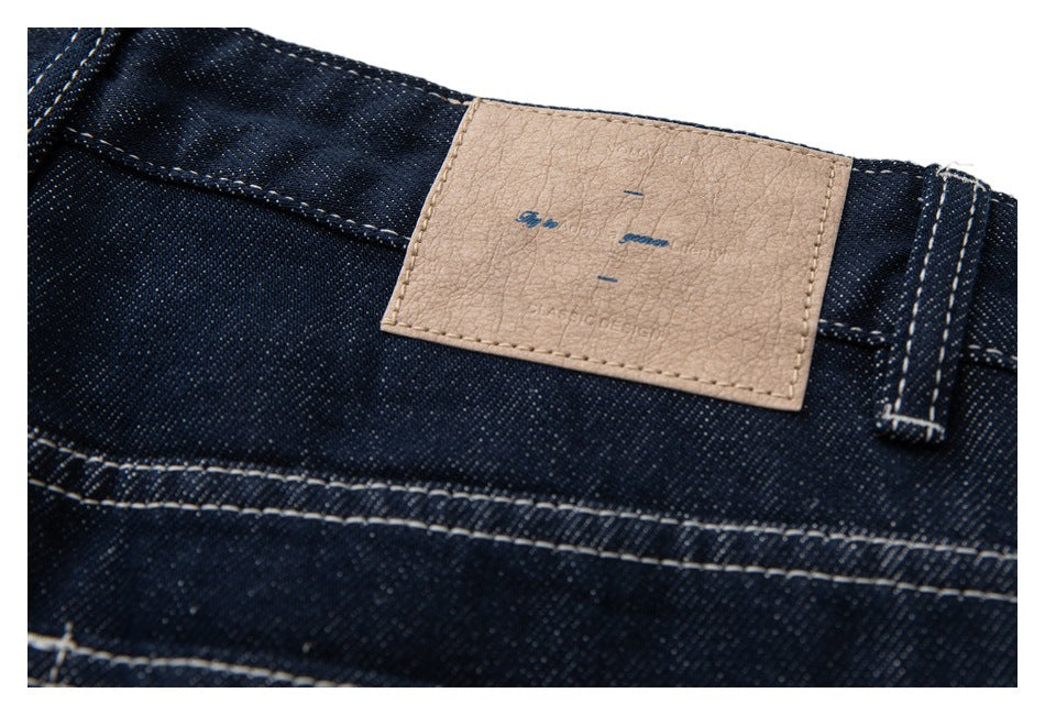 Close-up of the waistband showing a tan patch with faint lettering and a belt loop.