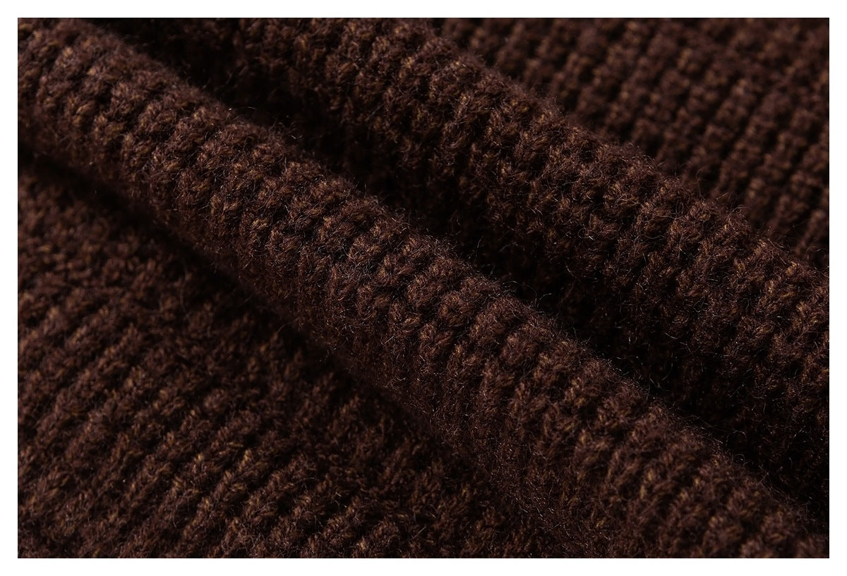 Extreme close-up showing the fuzzy, textured brown knit surface and seam.