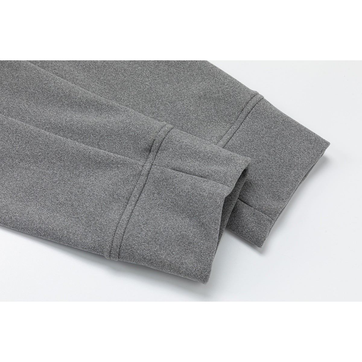 Close-up of the gray jacket sleeve cuff and stitched edge.