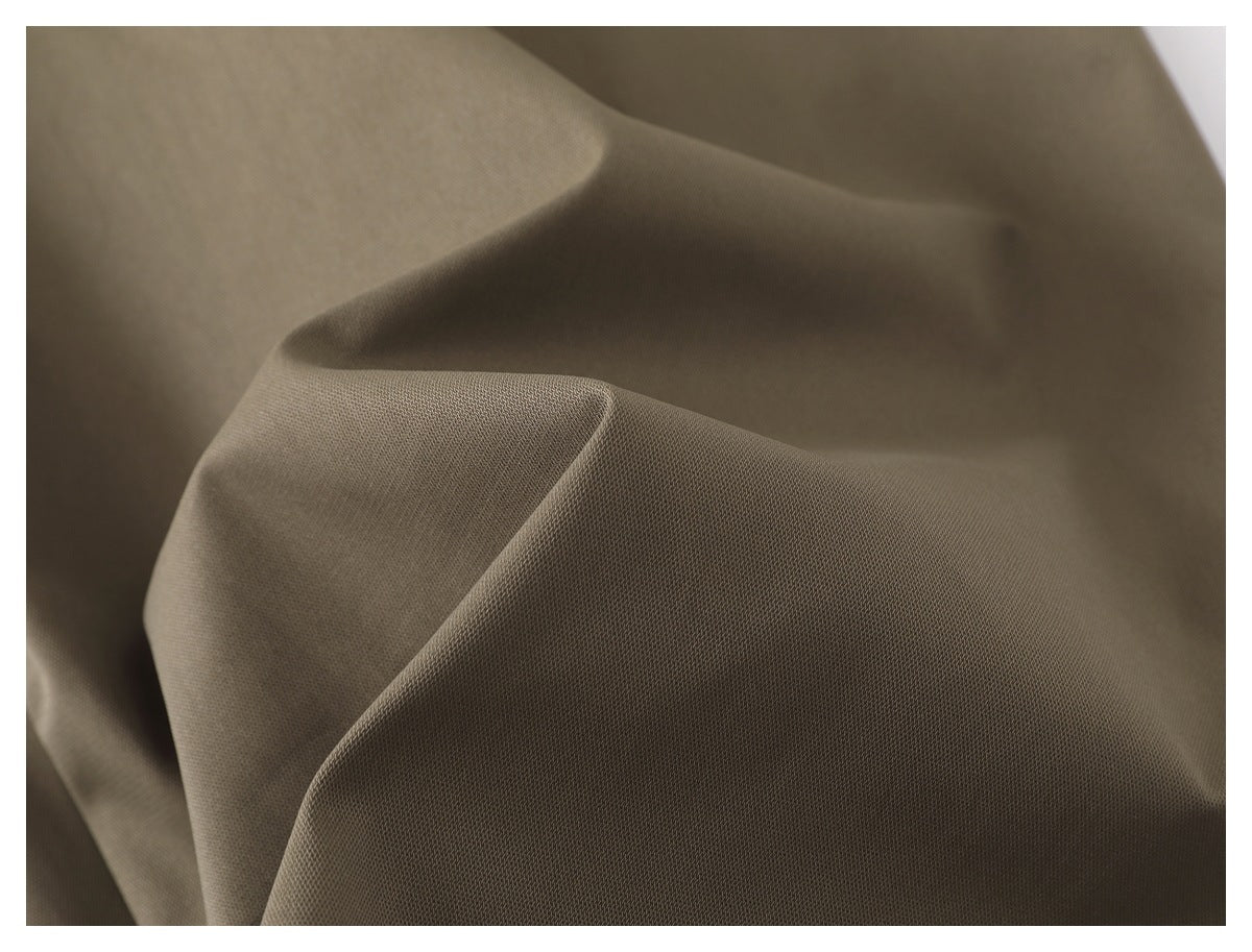 Macro view of the olive-taupe garment fabric, showing its fine surface texture and drape.