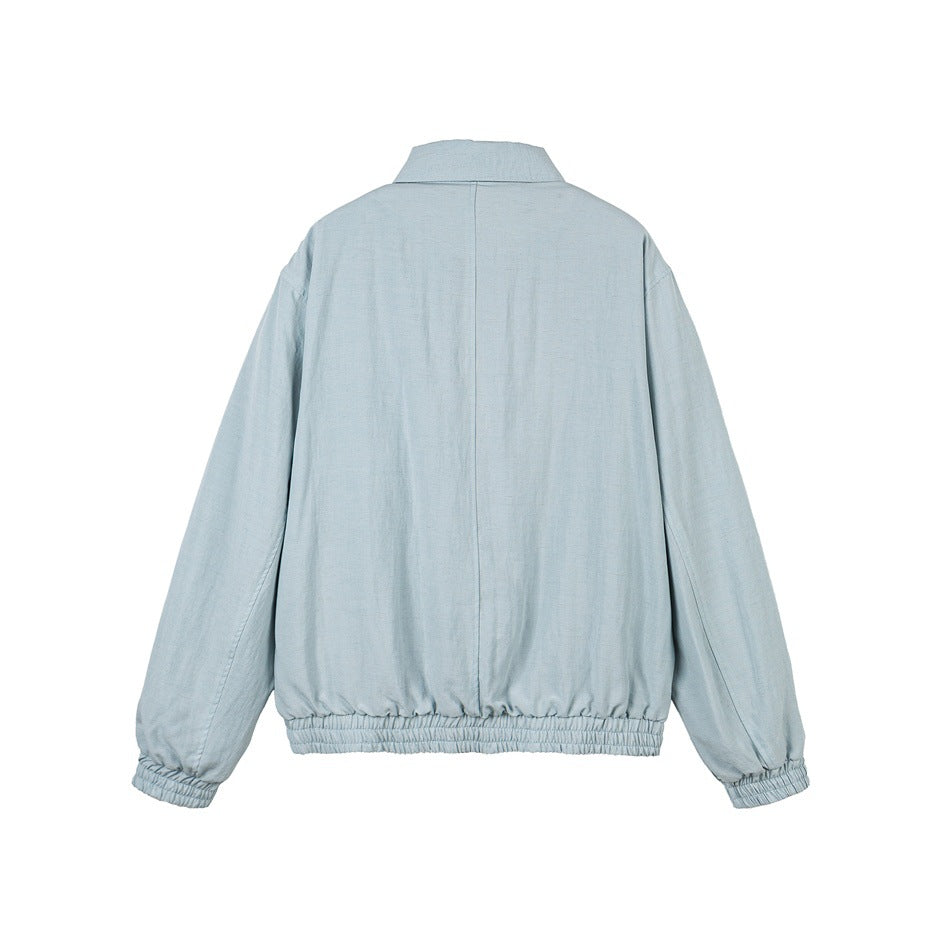Back view of a pale blue jacket with a center seam, long sleeves, elasticated cuffs and gathered hem.