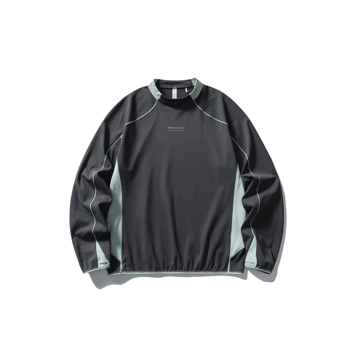 Dark gray long-sleeve mock neck top with light sage collar trim, side panels and piping-style stitching, flat lay