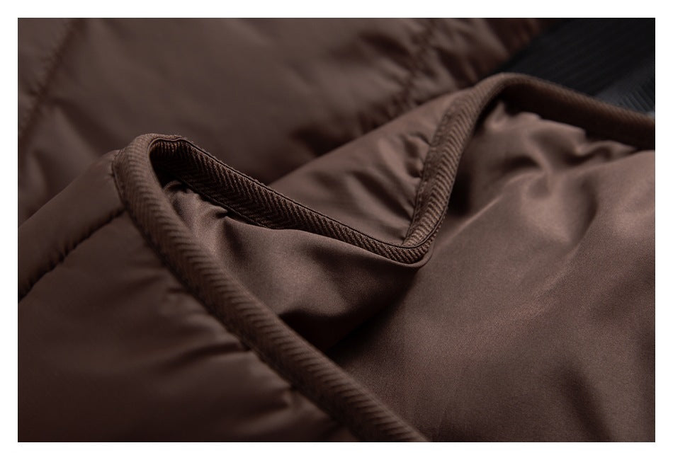 Close-up of brown quilted fabric and a curved, corded seam with dark brown trim.