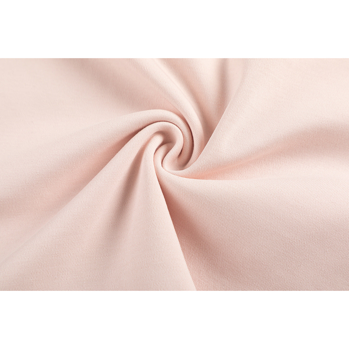 Close-up of pale pink knit fabric gathered into a swirl.
