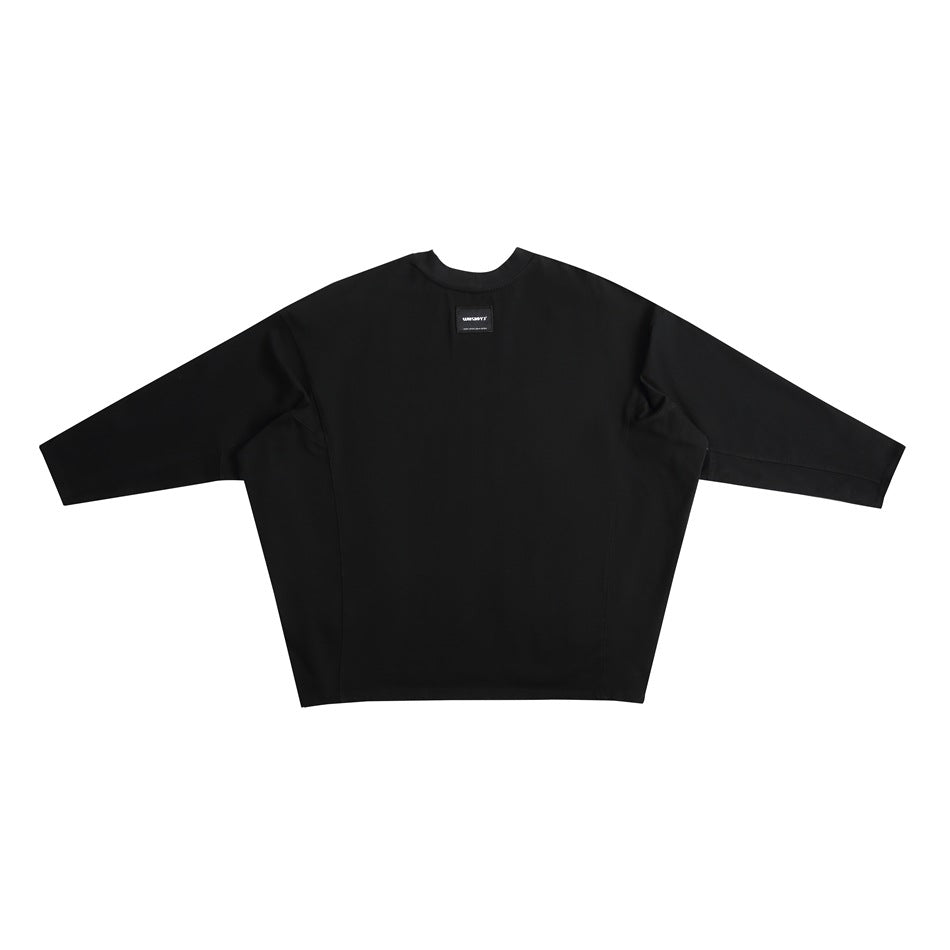 Flat-lay front view of an oversized black crew-neck top with wide sleeves and a small sewn-in neck label.