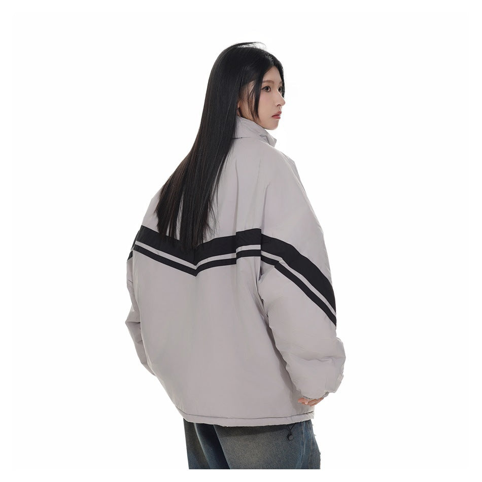 Model showing the back of a light gray jacket with black-and-white chevron stripes across the back and sleeves.