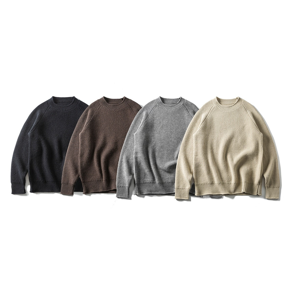 Four crew-neck rib-knit sweaters arranged together in black, brown, gray, and cream.