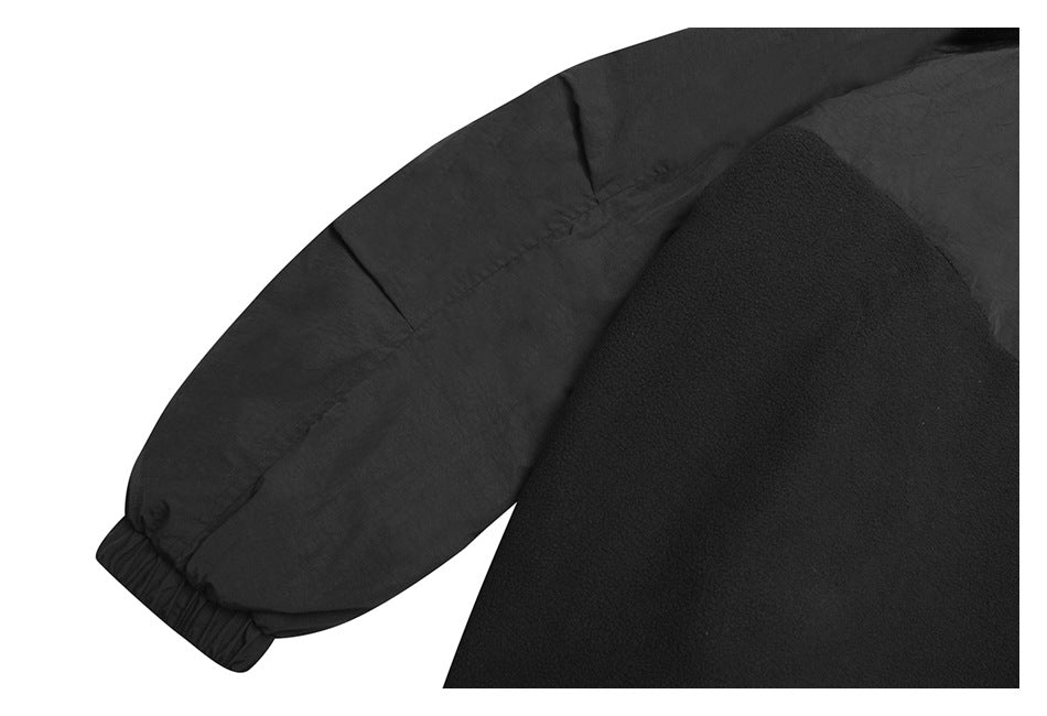 Close-up of a black garment showing a gathered elastic cuff and textured sleeve fabric.