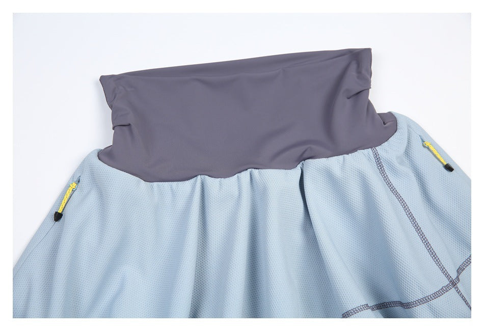 Close-up of a slate-gray waistband and light blue textured skirt with yellow side zipper pulls.