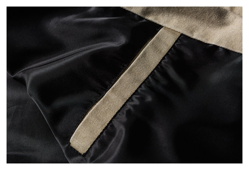 Close-up of black lining with a taupe-beige fabric trim strip.