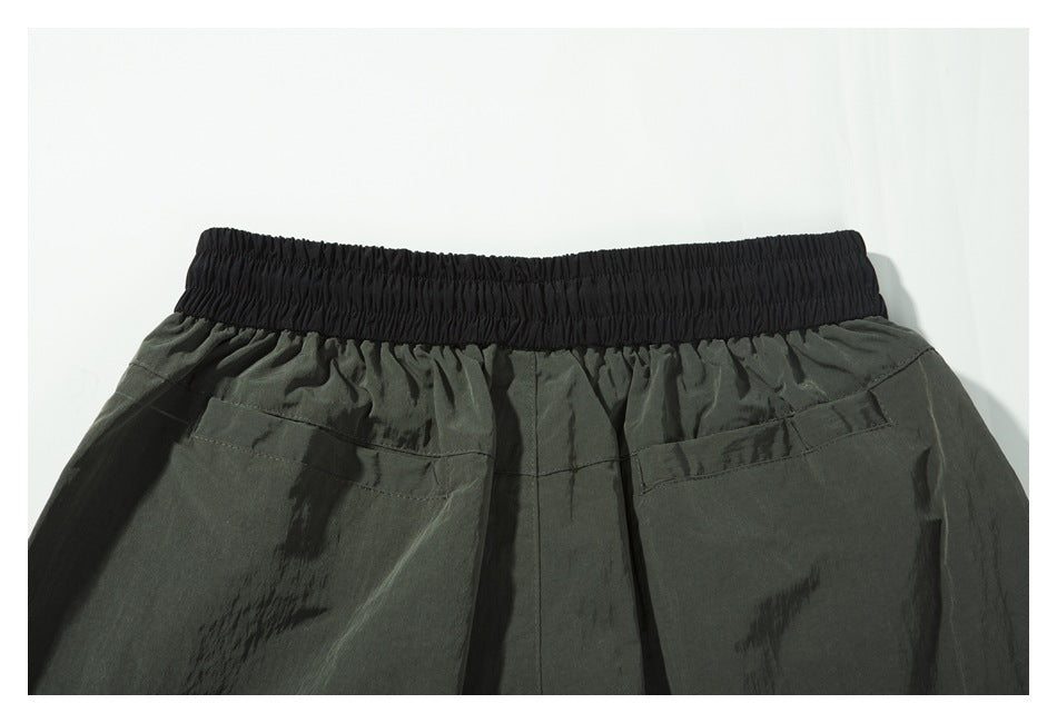 Close-up of the shorts' back, showing the black elastic waistband and two rear pockets.