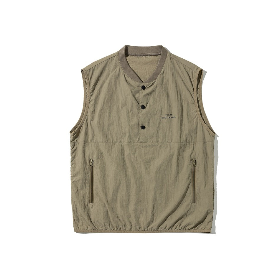 Khaki sleeveless vest flat lay with ribbed collar, three snaps, zippered pockets and small chest print
