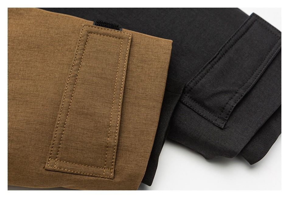 Close-up of brown and charcoal coat sleeve cuffs with stitched adjustment tabs.