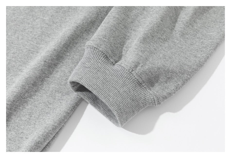Close-up of a gray sweatshirt sleeve ending in a ribbed cuff.
