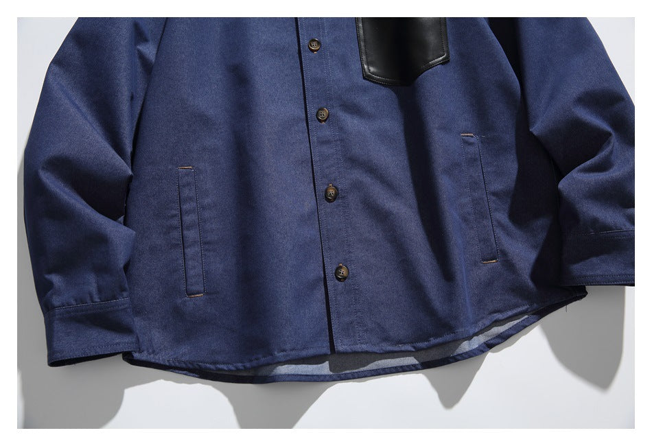 Cropped front view of a navy button-up shirt with a black chest pocket and two slim lower pockets.