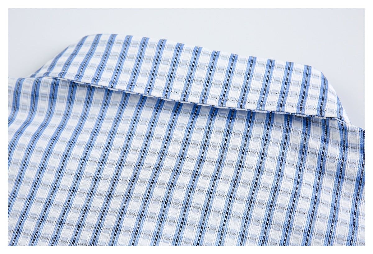 Close-up of the shirt collar in blue-and-white striped plaid fabric.