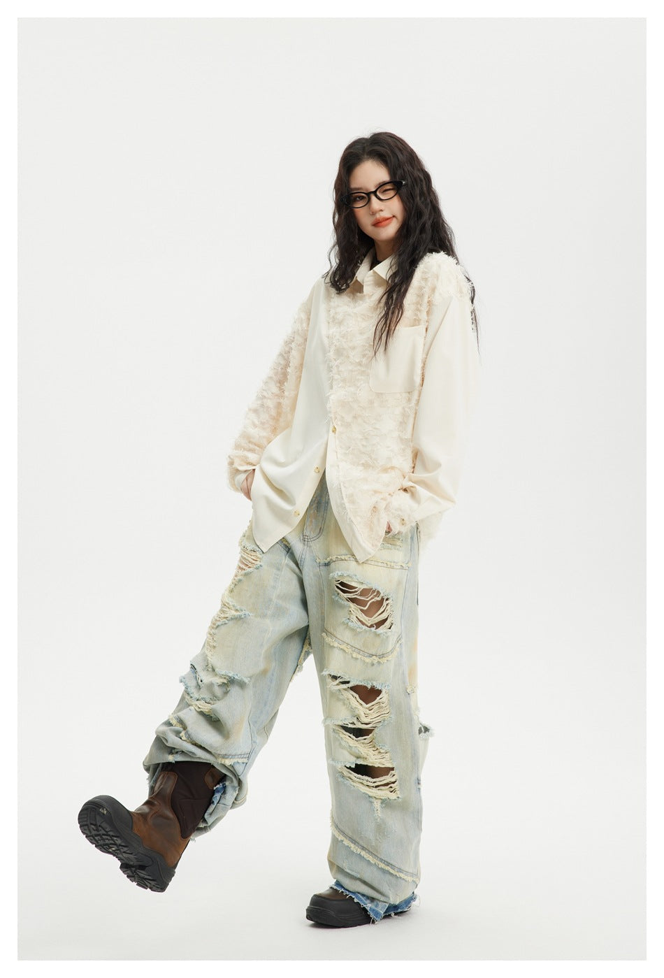 Model wearing an oversized ivory shirt with textured shaggy panels, a chest pocket, and heavily ripped light-wash jeans.