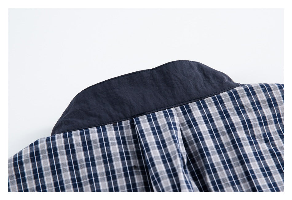 Close-up of the plaid shirt collar, showing a solid navy collar insert.