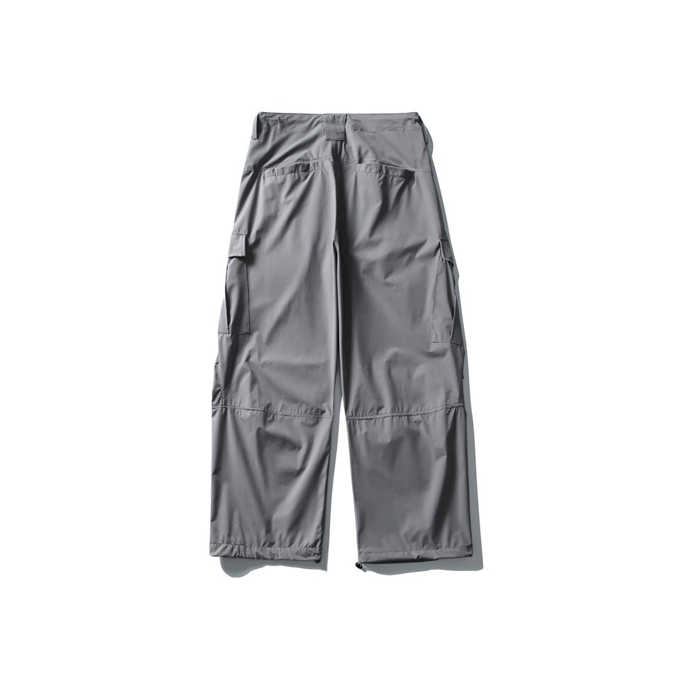 Back view of light gray wide-leg cargo pants with rear pockets and side cargo pockets.