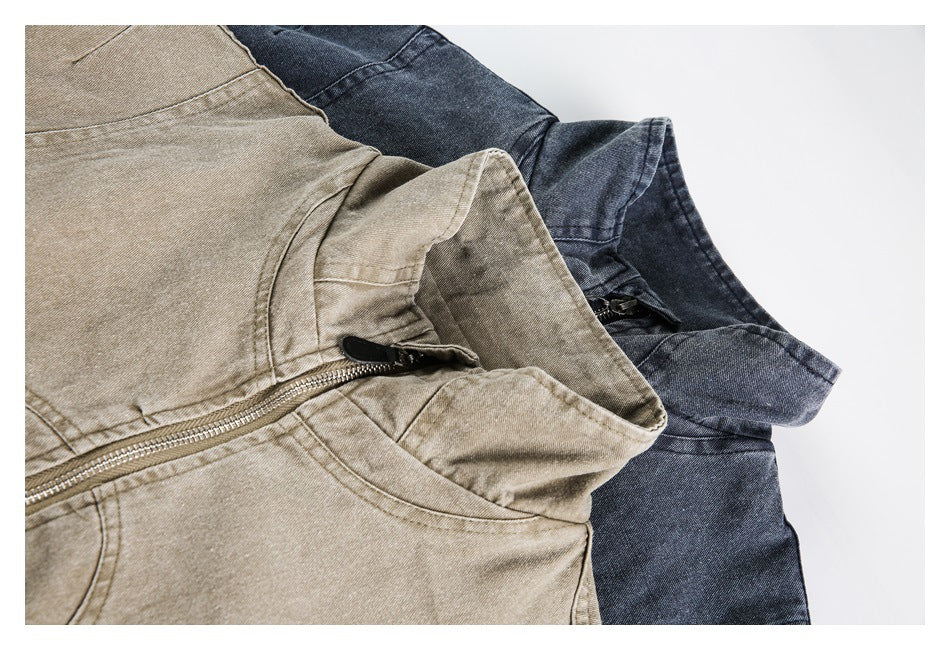 Close-up of tan and dark blue jackets showing their stand collars and front zippers.