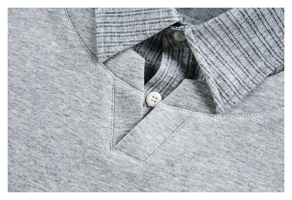 Close-up of a gray polo shirt's button placket, ribbed collar, and stitching.