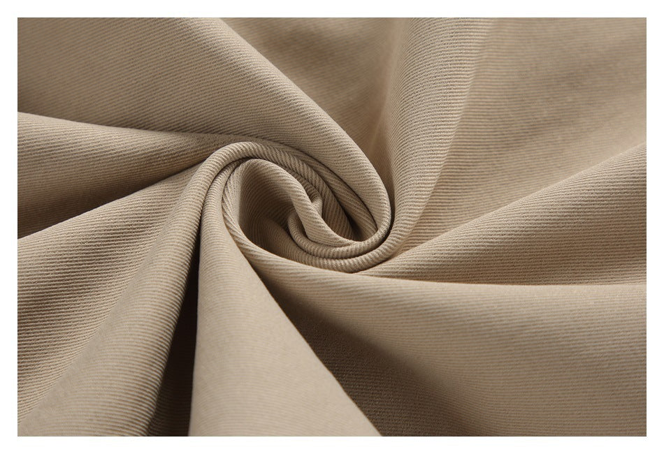 Close-up of beige woven fabric gathered into soft folds.