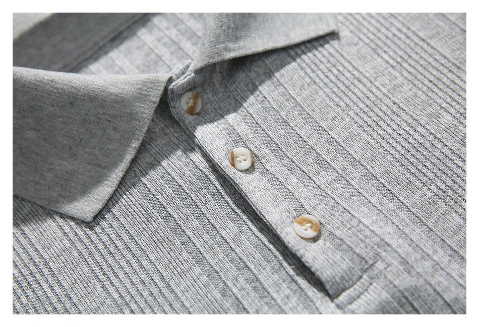 Close-up of the gray ribbed polo shirt's three-button placket and textured knit.