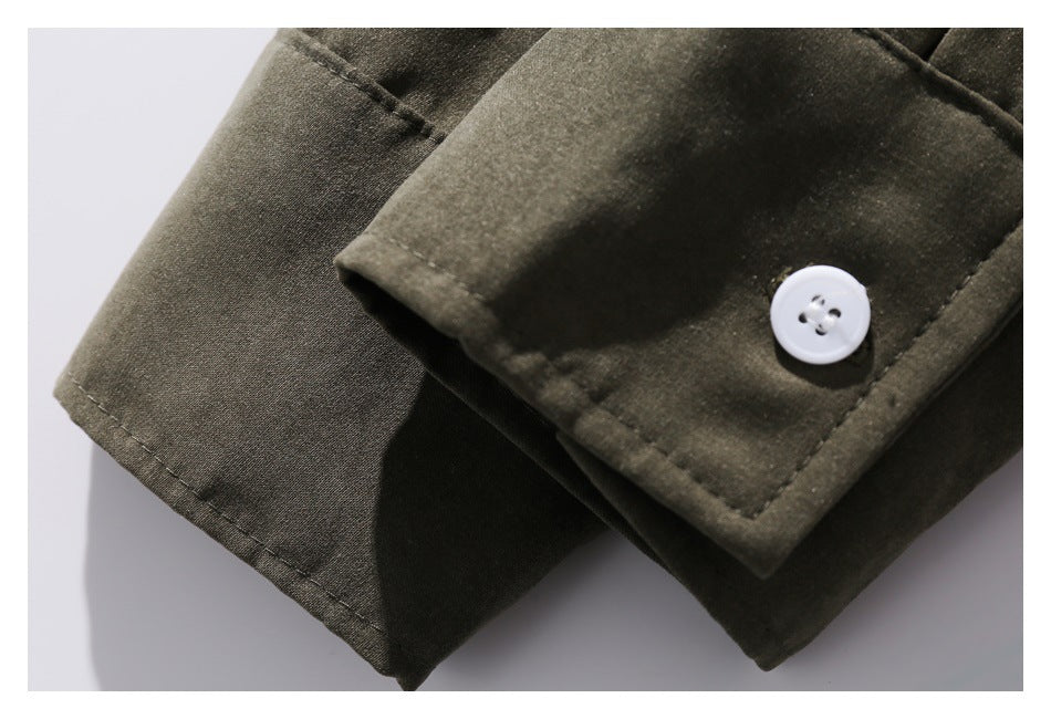 Close-up of an olive shirt cuff with a white button and visible stitching.