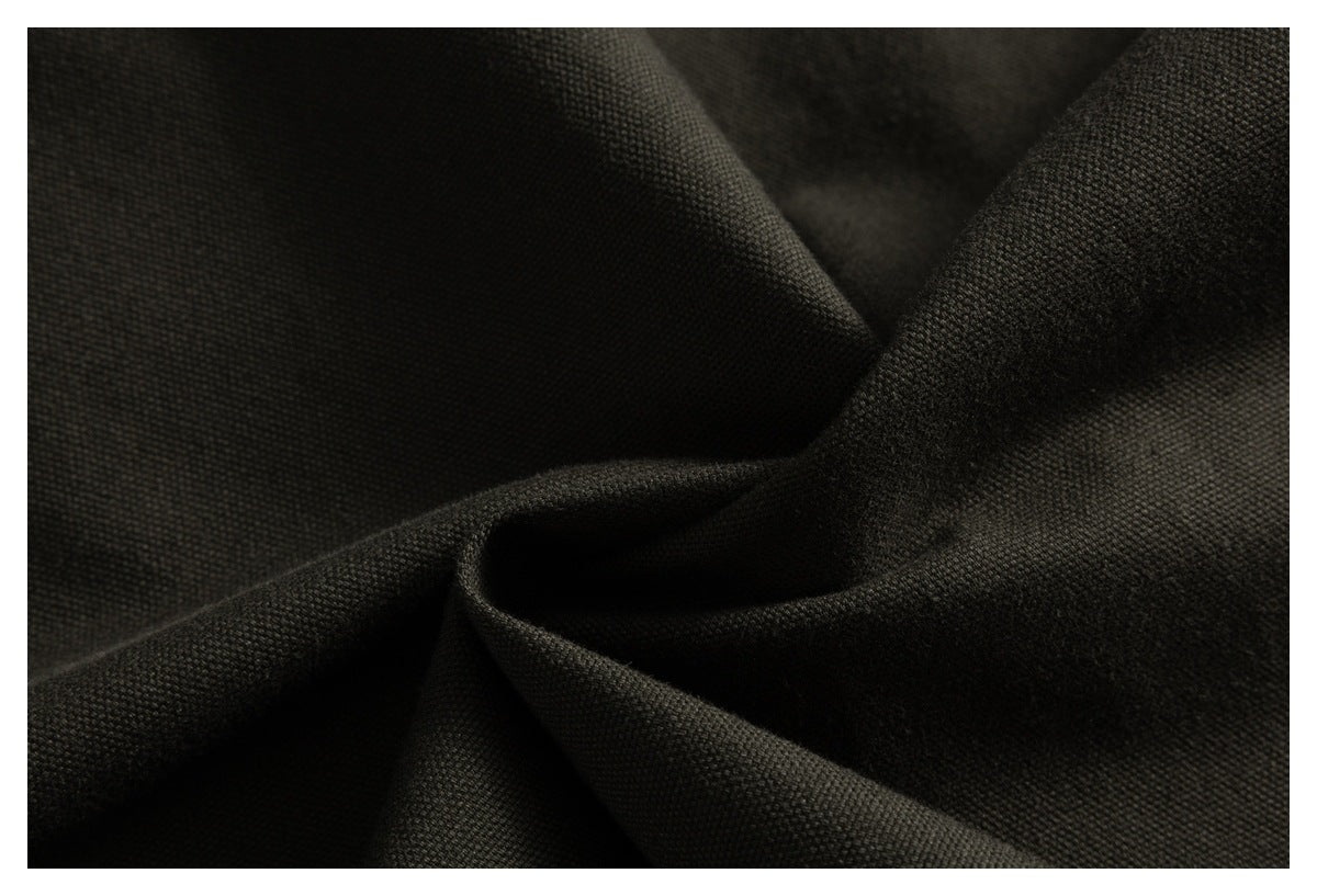 Close-up of dark charcoal textured fabric gathered into soft folds.