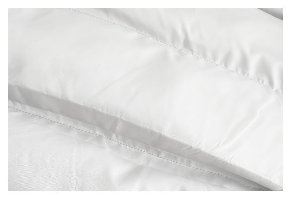 Close-up of white jacket lining and stitched seams.