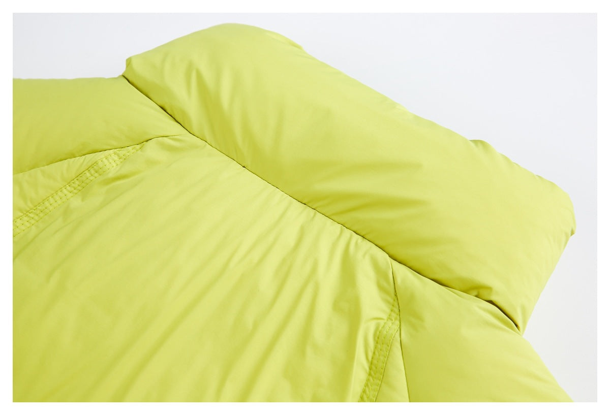 Close-up of the chartreuse padded jacket's shoulder and panel stitching.