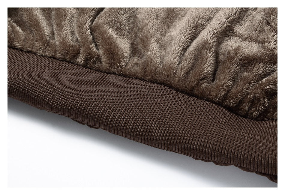 Close-up of plush brown jacket lining above a wide ribbed hem.