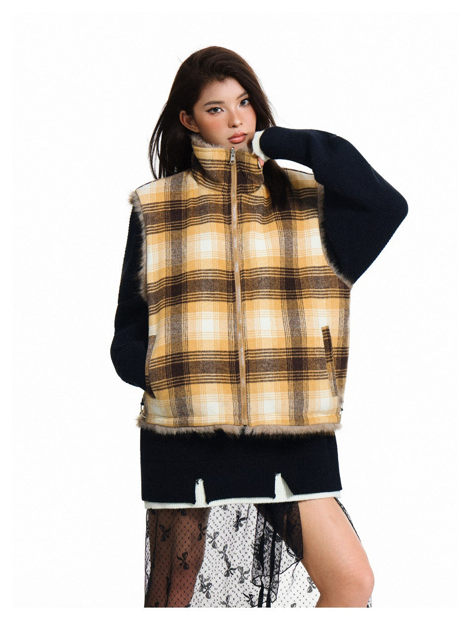 Model wearing a yellow, cream and brown plaid zip-front vest over a dark sweater.