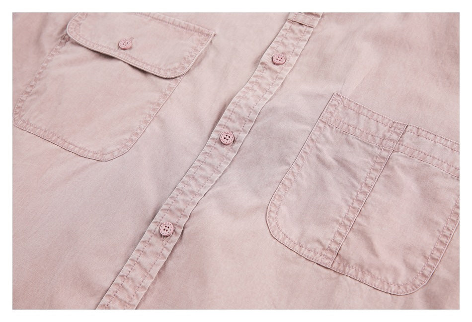 Close-up of a dusty pink button-up shirt front with two patch pockets and matching buttons.