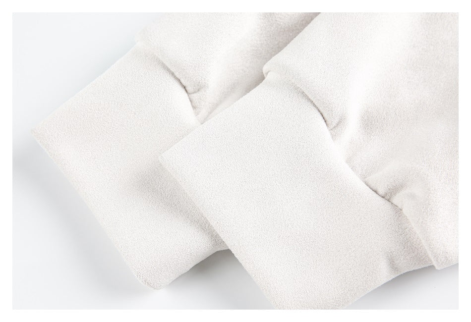 Close-up of pale cream sleeve ends with wide folded cuffs.