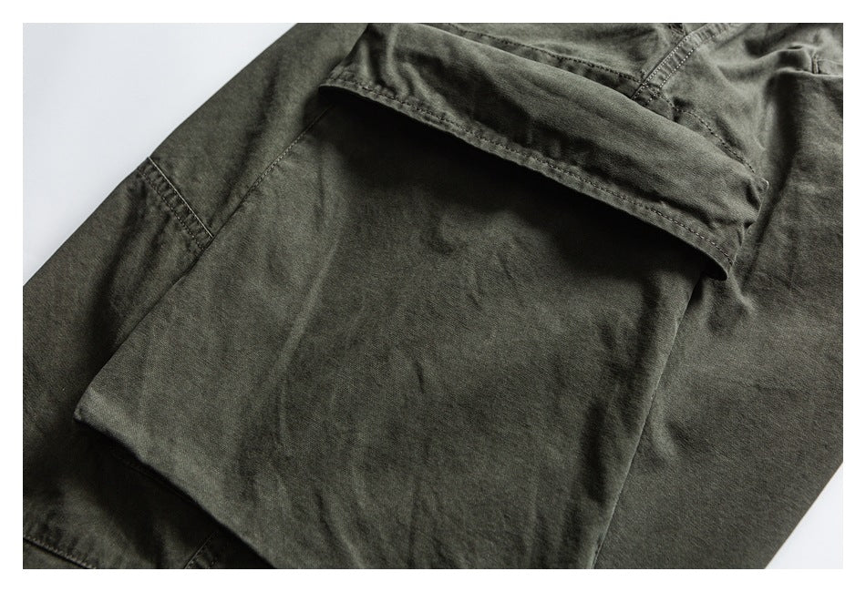 Close-up of an olive trouser leg with a large flap cargo pocket.