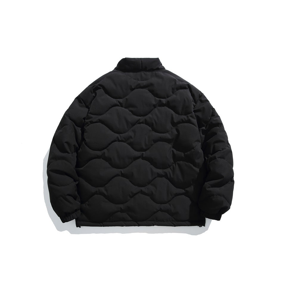 Back view of black quilted jacket with wavy stitching, raised collar and elastic cuffs, flat lay